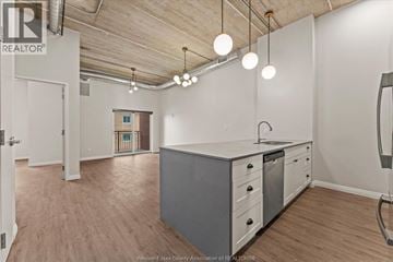 Windsor apartment for rent - A kitchen area with a white counter and grey cabinets.