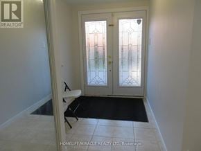 Richmond Hill (Devonsleigh) apartment for rent - A white door with a glass window is in a room with a black mat on the floor.