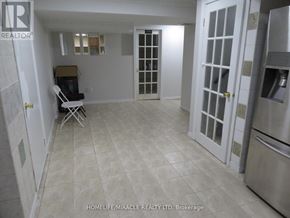 Richmond Hill (Devonsleigh) apartment for rent - A kitchen area with a refrigerator, sink, and a chair.