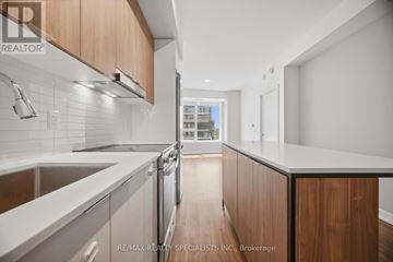 Mississauga (Hurontario) condo for rent - A modern kitchen with wooden cabinets and stainless steel appliances.