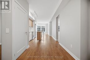 Mississauga (Hurontario) condo for rent - A long hallway with a washer and dryer in the distance.