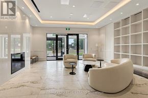 Toronto (Humber Heights) condo for rent - A white reception area with a logo on the wall and a glass door in the background.