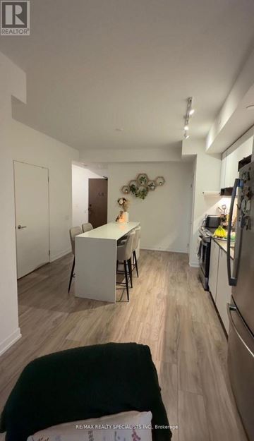 Mississauga (City Centre) condo for rent - A kitchen with a table and chairs in the middle of the room.