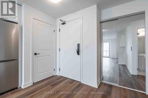 Burlington (Brant) condo for rent - A white door with a black handle is in the middle of a room.