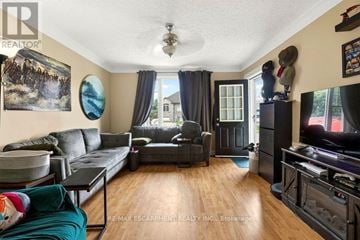 Thorold (Thorold Downtown) apartment for rent - A living room with a grey couch and a black coffee table.