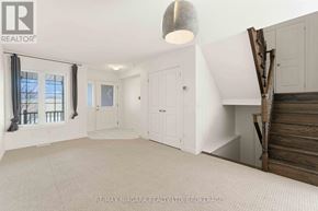 Thorold (Confederation Heights) townhouse for rent - A spacious room with white walls and a large window with a view of the sky.