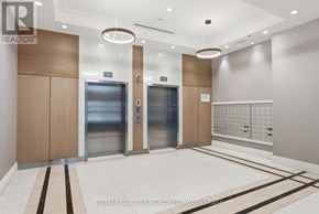 Niagara Falls (Hospital) condo for rent - A hallway with elevators and a wall of windows.