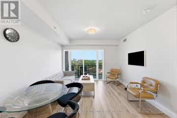 Niagara Falls (Hospital) condo for rent - A living room with a glass table and chairs.