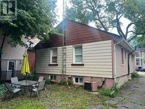 Toronto (Lansing-Westgate) apartment for rent - A house with a red roof and a patio table with chairs.
