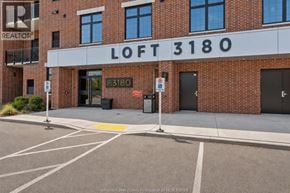 Windsor apartment for rent - A brick building with a sign that says "LOFT 3180" in front of it.