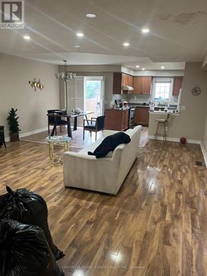 Brampton (Sandringham-Wellington) townhouse for rent - A living room with a white couch and wooden floors.