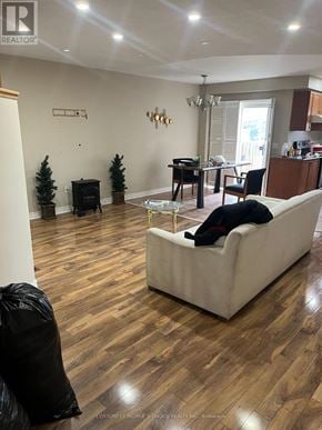 Brampton (Sandringham-Wellington) townhouse for rent - A living room with a white couch and wooden floors.