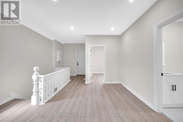 Kawartha Lakes (Lindsay) apartment for rent - A spacious room with light wood flooring and white walls.