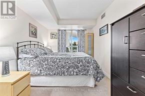 Toronto (Clairlea-Birchmount) condo for rent - A bedroom with a bed, nightstand, and a dresser.