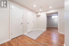 Mississauga (Cooksville) apartment for rent - A room with wood flooring and white walls, with a door on the left and a window on the right.