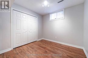 Mississauga (Cooksville) apartment for rent - A bedroom with wood flooring and a white door.
