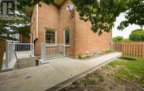 Brampton (Brampton South) apartment for rent - A brick house with a white fence and a tree in front.
