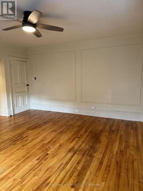 Toronto (Casa Loma) multi-family for rent - A room with wooden floors and a ceiling fan.