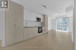 Toronto (Waterfront Communities) condo for rent - A spacious kitchen with wooden cabinets and a modern design.
