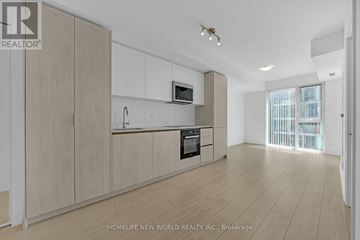 Toronto (Waterfront Communities) condo for rent - A spacious kitchen with wooden cabinets and a modern design.
