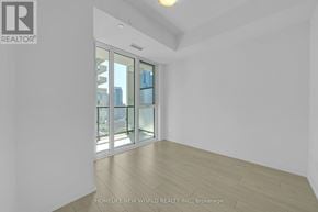 Toronto (Waterfront Communities) condo for rent - A room with a sliding glass door leading to a balcony.