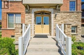 Whitchurch-Stouffville (Stouffville) apartment for rent - A house with a stone facade and a wooden door.