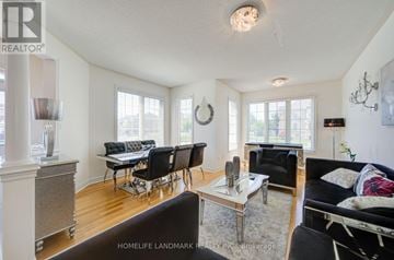 Whitchurch-Stouffville (Stouffville) apartment for rent - A living room with a black couch and a glass table.