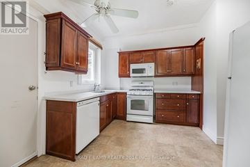 Toronto (East End-Danforth) apartment for rent - A kitchen with brown cabinets and white appliances.