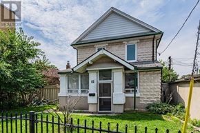 Toronto (East End-Danforth) apartment for rent - A house with a white door and a black fence in front.