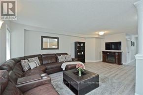 Whitby (Brooklin) townhouse for rent - A living room with a brown leather couch and a coffee table in the center.