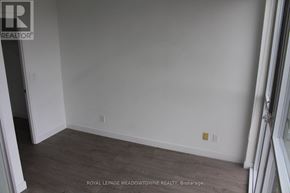 Toronto (Woodbine Corridor) condo for rent - A room with a wooden floor and white walls.