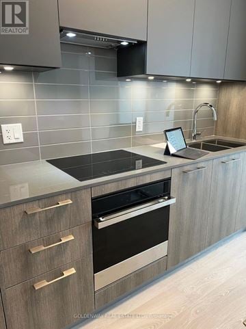 Markham (Unionville) condo for rent - A modern kitchen with a laptop on the counter.