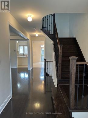 Newmarket (Stonehaven-Wyndham) apartment for rent - A hallway with a staircase and a mirror on the wall.