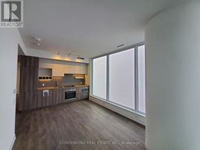 Vaughan (Vaughan Corporate Centre) condo for rent - A modern kitchen with wooden floors and a large window.