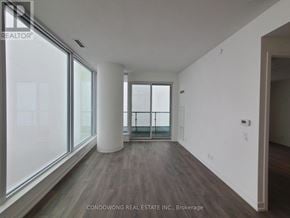 Vaughan (Vaughan Corporate Centre) condo for rent - A room with a large window and a wooden floor.