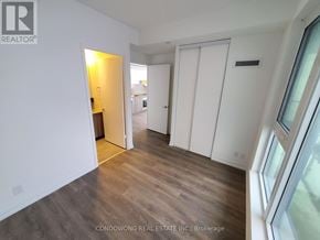 Vaughan (Vaughan Corporate Centre) condo for rent - A room with white walls and wooden flooring with a doorway leading to another room.