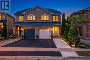 Brampton (Fletcher's Meadow) apartment for rent - A large house with a driveway in front of it.