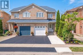 Brampton (Fletcher's Meadow) apartment for rent - A large house with a driveway in front of it.