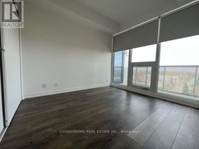 Toronto (Willowdale East) condo for rent - A room with a large window and wooden flooring.