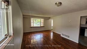 Oshawa (Centennial) apartment for rent - A room with wooden floors and a window with blinds.