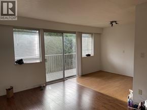 Burnaby apartment for rent - A room with a sliding glass door and wooden flooring.