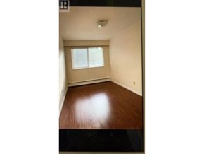 Burnaby apartment for rent - A room with a window and wooden floor.