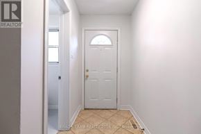Mississauga (Mississauga Valleys) townhouse for rent - A white door with a gold handle is in a hallway.