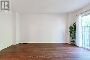 Mississauga (Mississauga Valleys) townhouse for rent - A room with wooden flooring and white walls, with a plant on the right side.