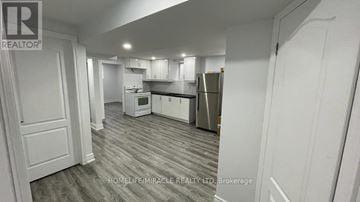 Mississauga (Meadowvale) apartment for rent - A brokerage image of a kitchen with white cabinets and a grey floor.