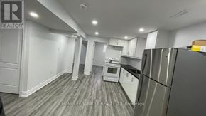 Mississauga (Meadowvale) apartment for rent - A kitchen with a refrigerator, microwave, and oven.
