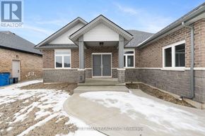 Chatham-Kent apartment for rent - A house with a snow-covered ground in front of it.