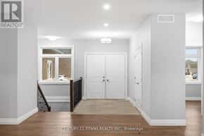 Chatham-Kent apartment for rent - A white hallway with a door and a window.