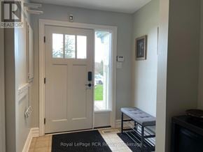 Blue Mountains townhouse for rent - A white door with a glass window is in a room with a bench.
