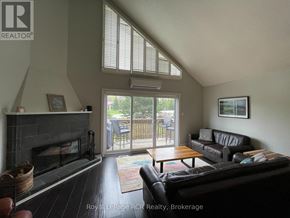Blue Mountains townhouse for rent - A living room with a fireplace and sliding glass doors.